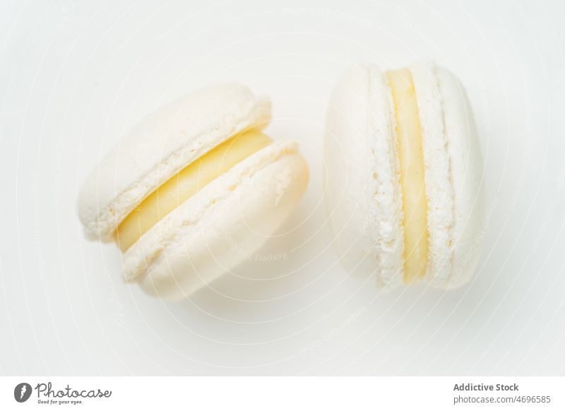 Vanilla macaroons with filling on table macaron vanilla dessert sweet confection confectionery indulge treat food flavor fresh tasty delicious yummy appetizing