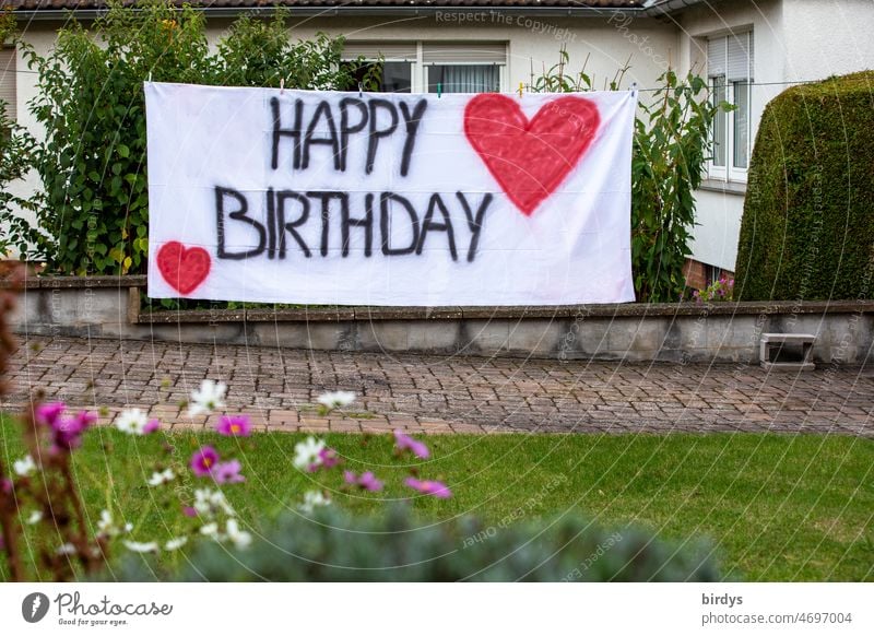 Happy birthday. Birthday greeting with writing and red hearts on a white cloth in the garden of a house Happy Birthday Birthday wish Feasts & Celebrations