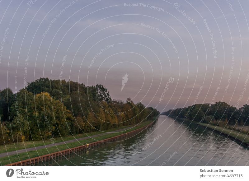 Straight water channel in Germany Münsterland at sunset in autumn Water Channel Autumn Landscape water canal River Waterway Nature background pretty Tree Park