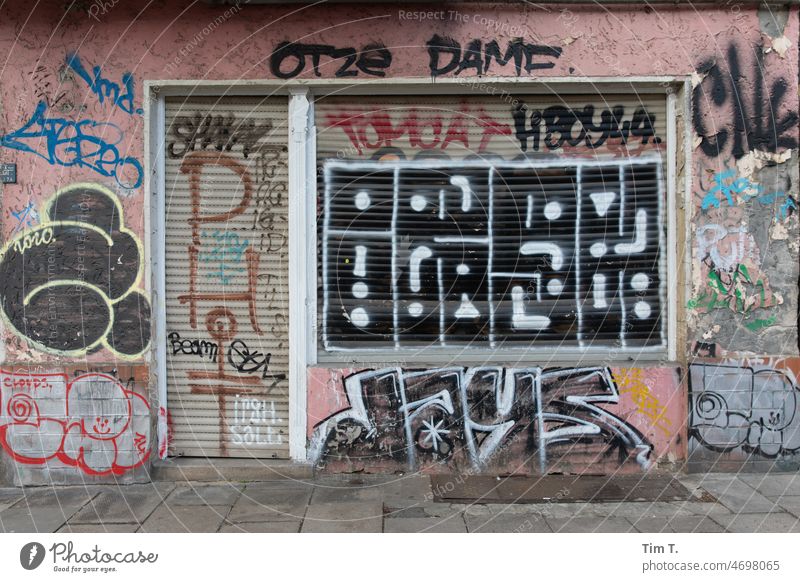 a closed store in Prenzlauer Berg Berlin Store premises Graffiti Town Exterior shot Capital city Downtown Deserted Day Old town Architecture Colour photo