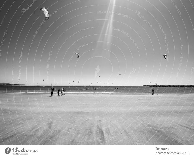 Black and white photo from beach in Portugal with kitesurfers vacation Vacation mood Vacation photo Sun Summer Summer vacation Kitesurfing Surfing Ocean