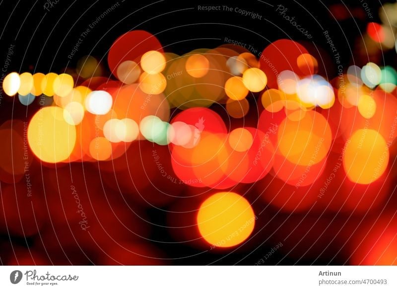 Blurred red and orange bokeh background. Blur abstract background of urban  light. Warm light with beautiful pattern of round bokeh. Light in the  night. Street lamp lights in the city at dark