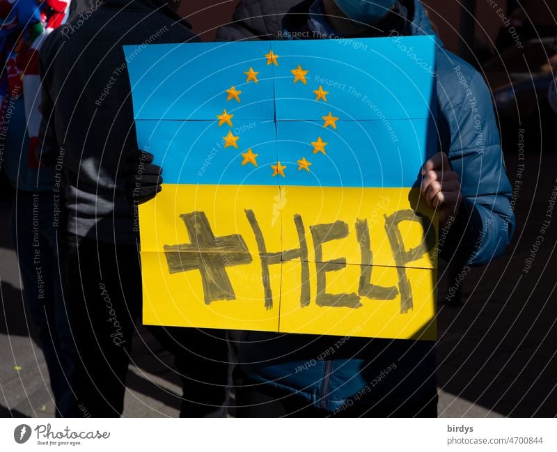 Peace demonstration , Ukrainians ask the European Union for help. Shield in the national colors of Ukraine and flag of the EU Demonstration Help demonstranted