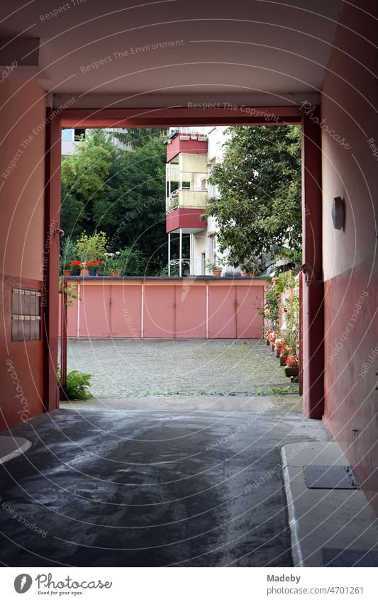 Passage in an old apartment building to the garages in the courtyard in summer in the north end of Frankfurt am Main in Hesse, Germany Rectangle North End