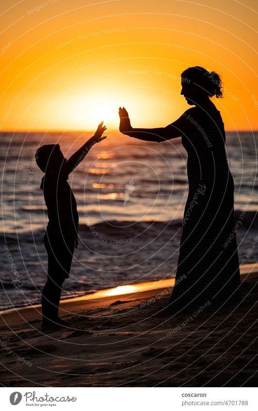 mother and son silhouette holding hands