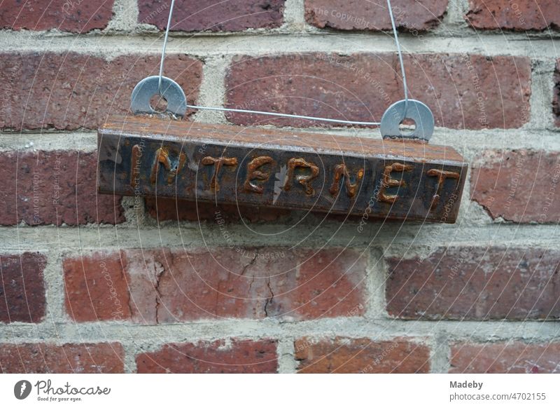 Rusty sign to the internet in front of an old factory wall made of red brick in the district Margaretenhütte in Gießen at the river Lahn in Hesse, Germany Stone