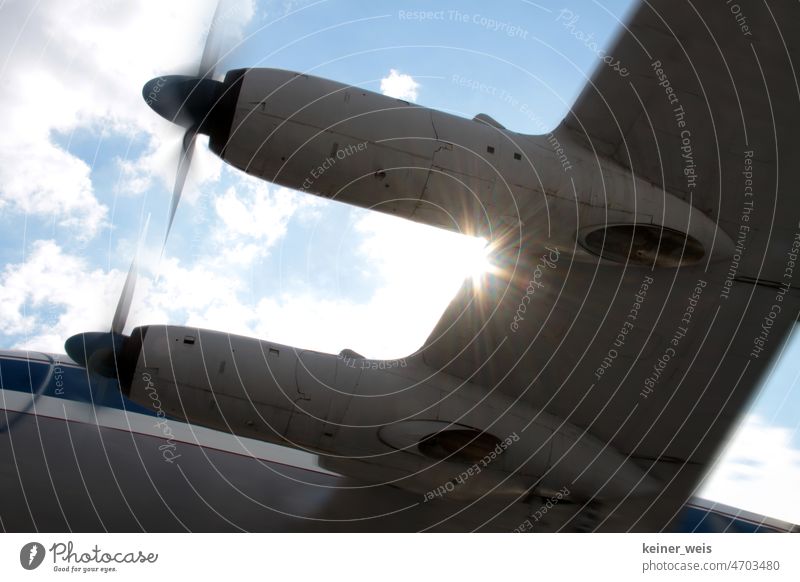 Wing on the aircraft of a propeller plane in the backlight of the sun Propeller Airplane propeller engine Sun Propeller aircraft propeller blades Engine