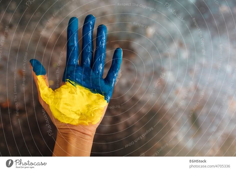 Female hands painted in the colors of the flag of Ukraine. No war and peace concept. ukrainian flag independence poster support blue symbol yellow breaking