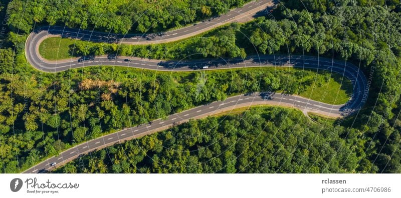 Winding road in the forest. Eifel, germany, Europe. Car passing on road. Drone Shot drone above adventure aerial avenue birdseye car curved curvy destination