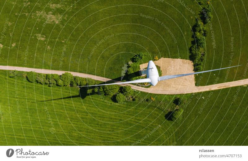 top aerial view of a wind turbine power windmill grid drone canola sustainable weather lines agriculture pollution clean over renewable eco windfarm alternative