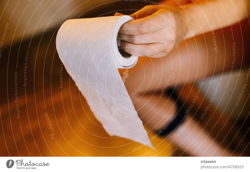 Toddler girl potty training holding toilet paper in bathroom Stock Photo -  Alamy