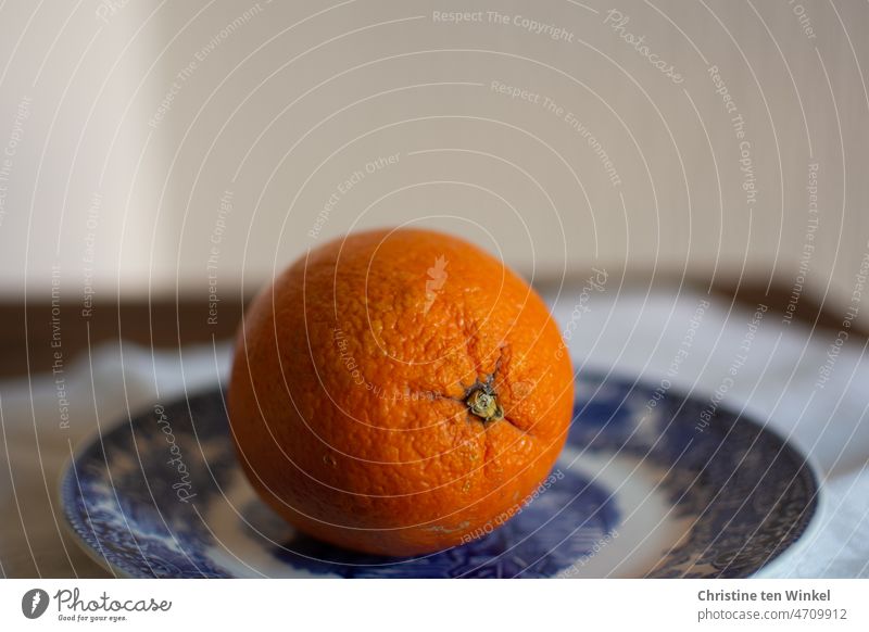 One organic orange on a white and blue plate Organic Orange Organic orange Organic produce Orange (fruit) Organic fruit Fruit Nutrition salubriously Delicious