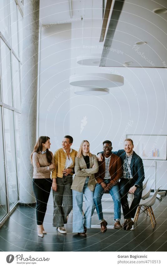 Group of positive businesspeople standing together in the office person diversity men women young african adult business meeting business people businessman