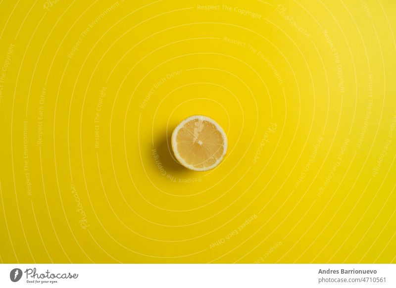 Lemon on vivid yellow background. Minimal summer concept. Flat lay. lemon ingredient citrus juice juicy organic macro raw ripe cut food vegetarian fruit fresh