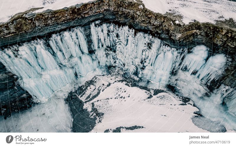 Snow melting and freezing on the rock walls creating beautiful waterfall formations standing water tranquility mine nature frost mineral glacier flowing snow