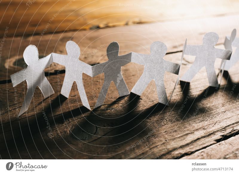 Paper People Holding Hands Teamwork paper people together concept team teamwork family chain help abstract conceptual diversity business hand background group
