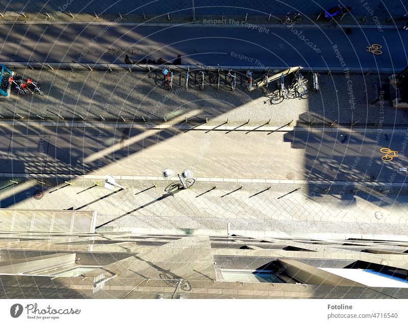 The world looks very different from above III -View from above on a part of Friedrichstraße in Berlin. The sun draws harsh shadows. Pedestrians are as small as miniatures.