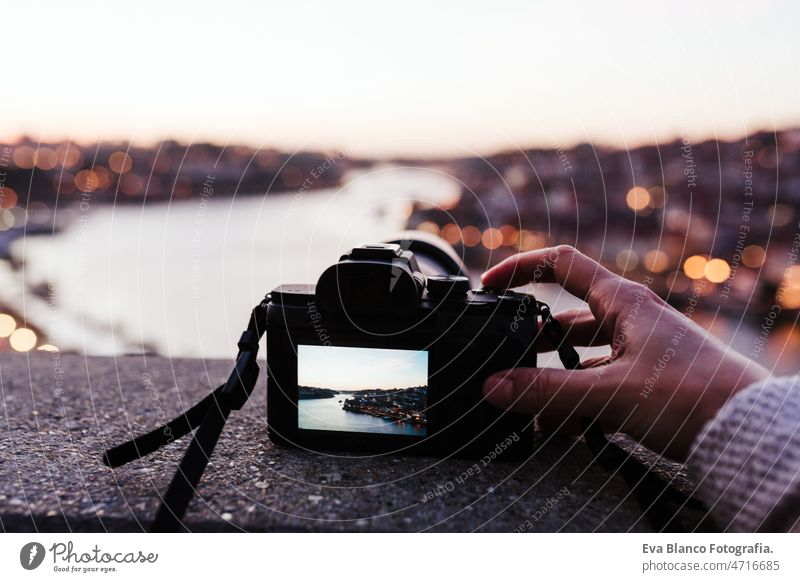 close up of woman in Porto bridge taking pictures with camera at sunset. Tourism in city Europe unrecognizable porto photographer screen travel tourist enjoy