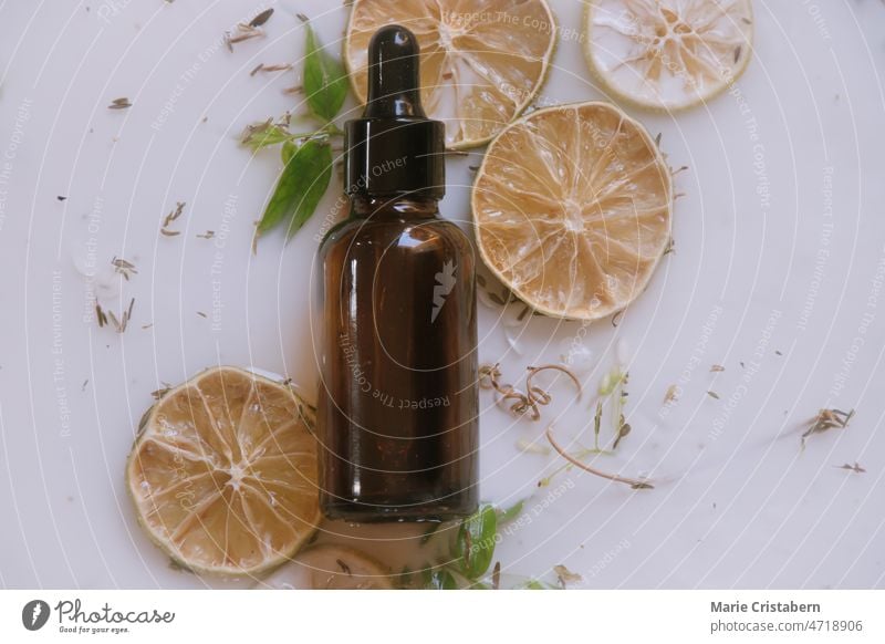 Natural cosmetic skincare serum packaging with leaf fern and fresh juicy  orange fruit on white background. Beauty vitamin ingredient. alternative  medi Stock Photo - Alamy