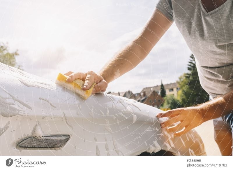 Outdoor Car wash worker Cleaning stains with foam soap. Leave space to  write a description of the message. Stock Photo