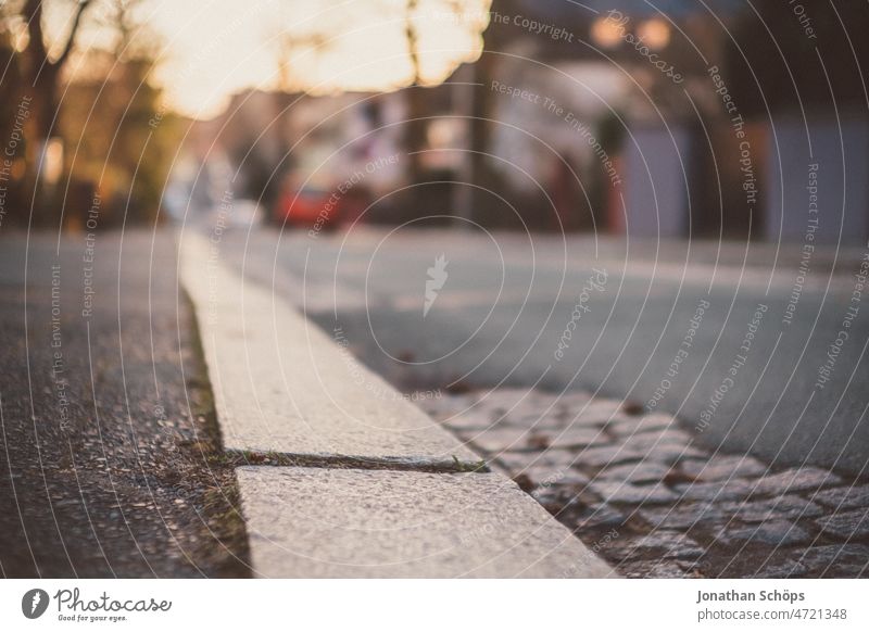 curb on a street in the evening sun Footpath Sidewalk off Curbside sunny Winter Roadside Pavement urban Empty Asphalt Cobblestones Street patchwork rug vintage