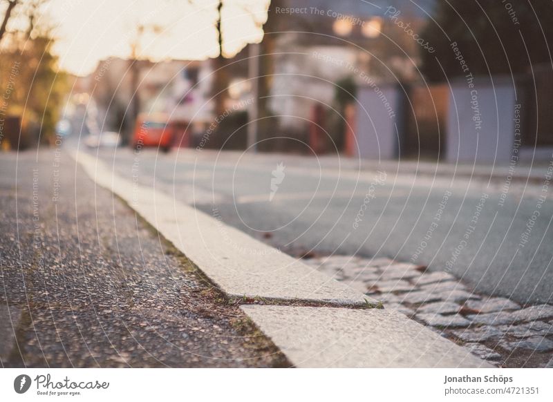 curb on a street in the evening sun Footpath off Curbside sunny Winter Roadside Pavement urban Empty Asphalt Cobblestones Street patchwork rug vintage Analog