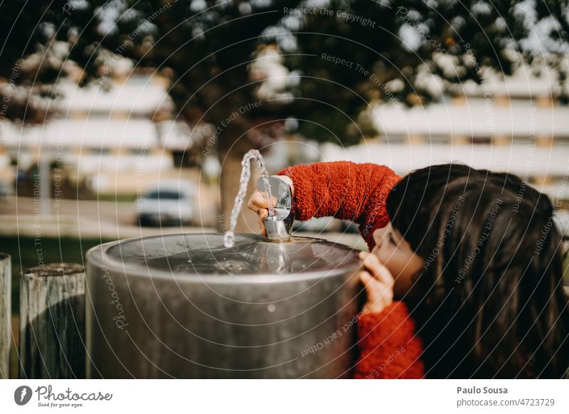 Cute girl playing with Park drinking Fountain Girl Child childhood real people Authentic Drinking Water happy fun lifestyle caucasian family cute Drinking water