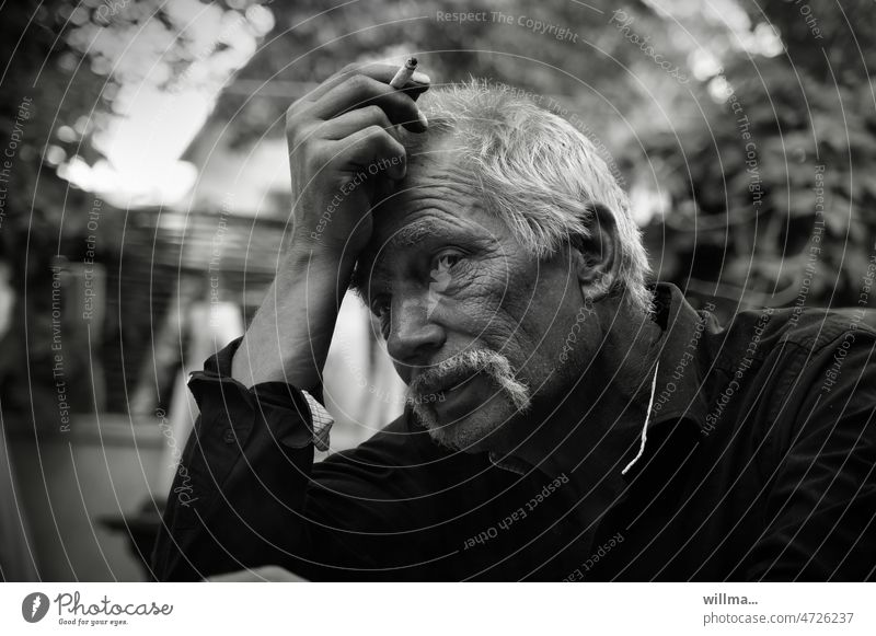 Thoughtful older man with a cigarette Man portrait Meditative Facial hair White-haired smoking Think ponder Dialog partner Hope Remember Loneliness mustache