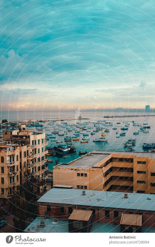 Vertical shot of Alexandria Bay, amazing golden hour at sunrise. View of the surroundings from a high residential building, so many fishing boats anchored in the harbor