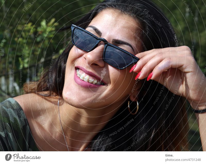 Woman with sunglasses Feminine Smiling Sunglasses Laughter Jewellery Braces Dark-haired Long-haired out sunny
