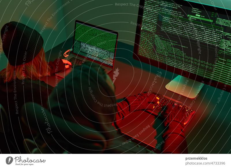 Anonymous people using computer and programming to break code. Cyber security threat. Internet and network security. Access to private information. Anonymous hackers using technology to access to password and encrypted data