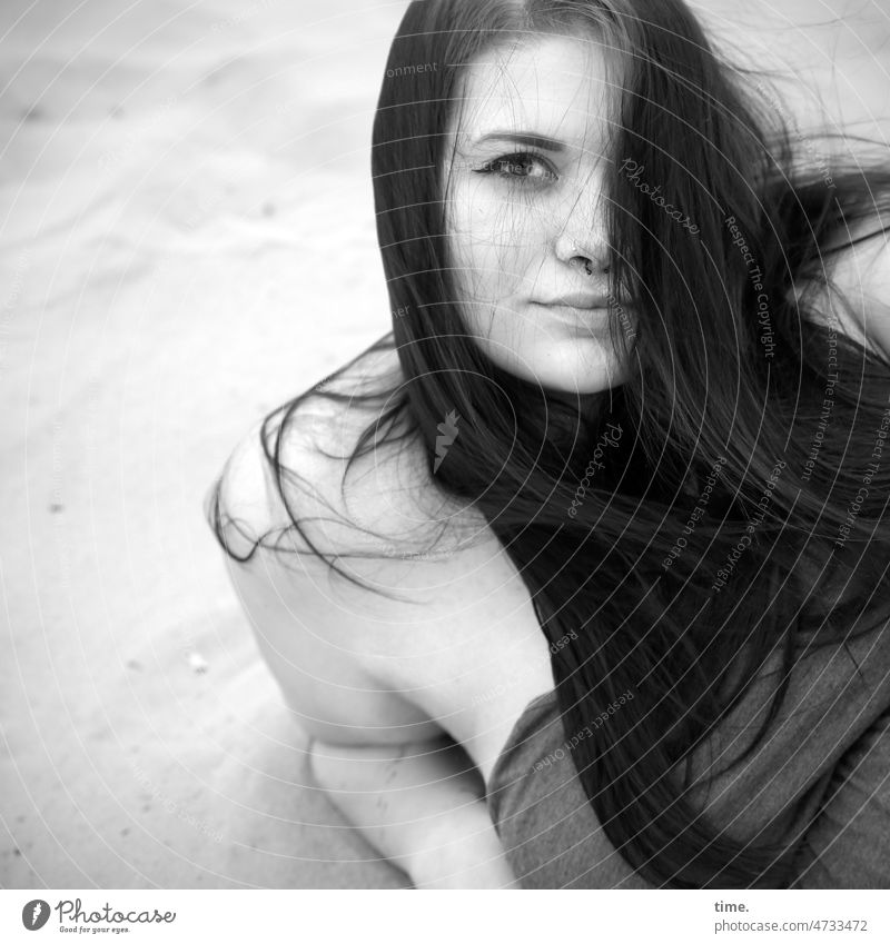Woman in sand, propping herself up Feminine portrait feminine Dress Long-haired Dark-haired Looking into the camera Sand