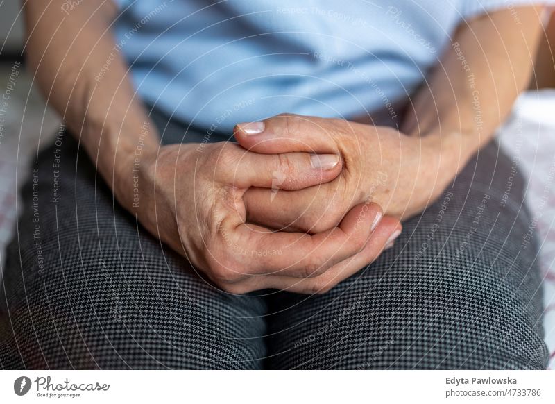 Close up shot of a hands of a senior woman arthritis rheumatism stiff joints massaging wrist osteoporosis wrinkled skin wrinkles close up disease illness unwell