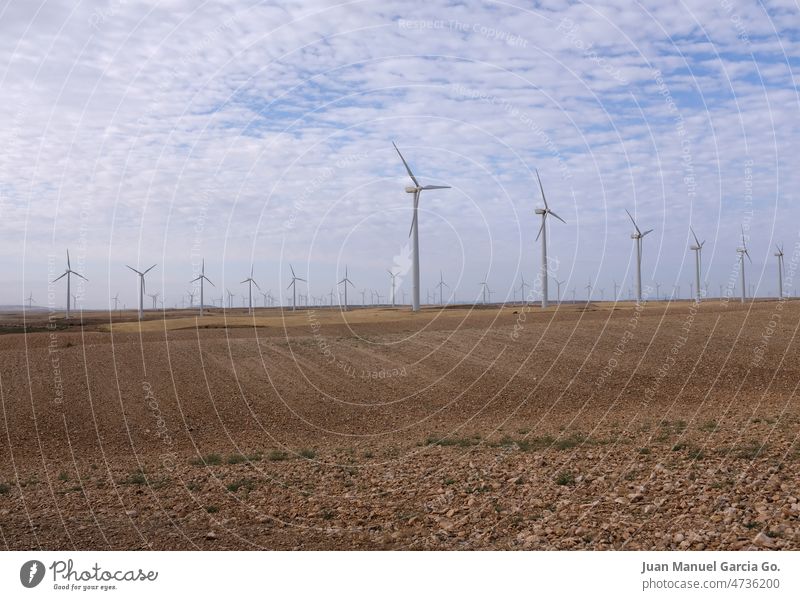 Wind farm in dry farmland. Alternative energy to the fossil fuel crisis alternative wind electricity insufficiency renewable green generator desert windmill