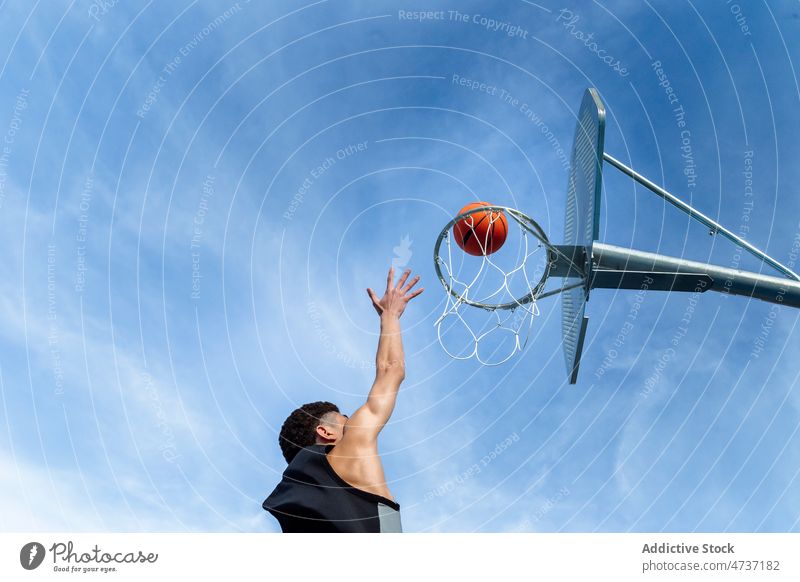 Faceless man throwing ball in hoop sportsman basketball game play score training goal blue sky player hobby streetball challenge athlete activity male summer