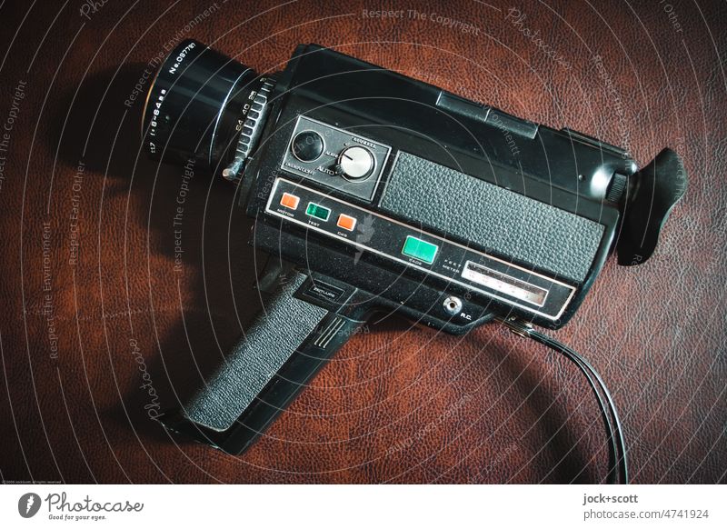 Video camera Hi-Deluxe Super 8 lies on imitation leather Retro Style 70s Past Technology Dust Synthetic leather Design Objective Key rotary knob Lettering