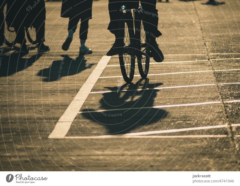 Silhouette of people, riding a bike or strolling in the sunshine Human being Shadow Sunlight Neutral Background Woman Man Lanes & trails Shadow play Bicycle