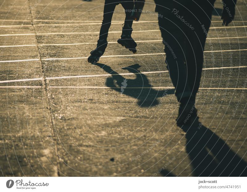 Silhouette of people, rollerblading or walking in the sunshine Human being Shadow Sunlight Neutral Background Lanes & trails Shadow play Back-light