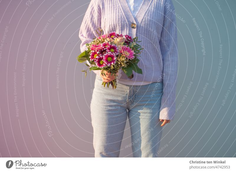 Color contest | pink and light blue Bouquet Spring Young woman portrait pose Light and shadow flowers blossom light colours Hand Blossoming pretty stop