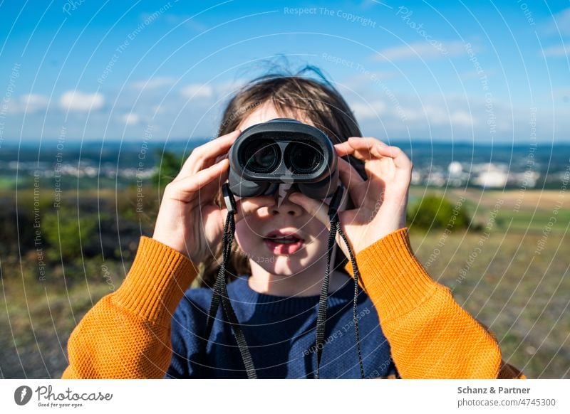 Child looking through binoculars Curiosity inquisitorial Hiking Interest interest In transit Adventure ChildGirl Landscape Binoculars Looking Far-off places