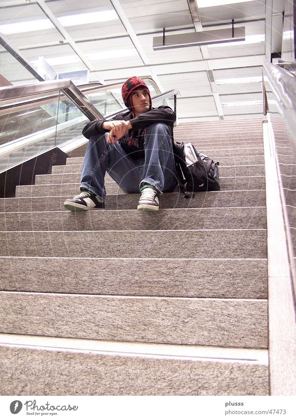 absorbed in thought Style School building Man Adults Youth (Young adults) Train station Airport Escalator Think Sit Dream Wait Loneliness Target Thought Aimless