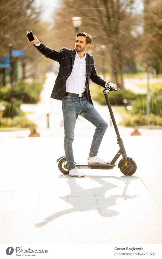 Young businessman using mobile phone  on electric scooter active adult casual caucasian cellphone city communication concept connected connection connectivity