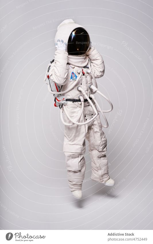 Anonymous astronaut in spacesuit and helmet in studio safety universe science cosmos explore mission person pilot ready spaceman explorer cosmonaut astronomy