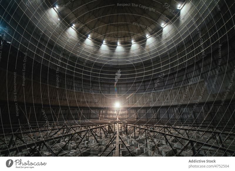 Round room of abandoned industrial facility industry dark dome lamp weathered grunge spacious illuminate structure construction building factory interior