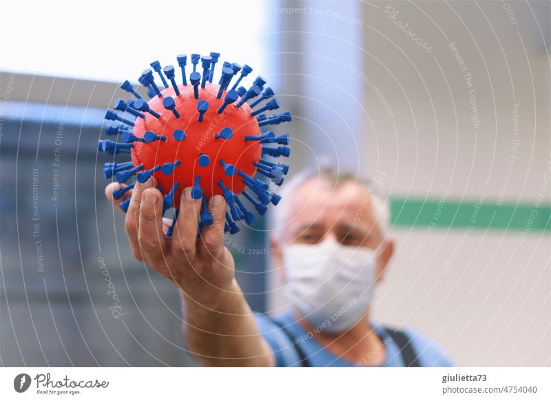 The Corona virus from the workshop | Man with mask proudly holds the virus in his hand Virus 3D corona corona thoughts covid-19 Handcrafts Self-made Dangerous