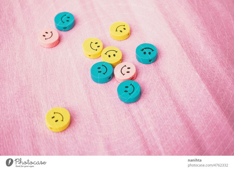 Smiley faces in pastel tones against a pink background smiley pieces emoji positive positivity happy happiness fun fresh colorful blue yellow cyan palette diy