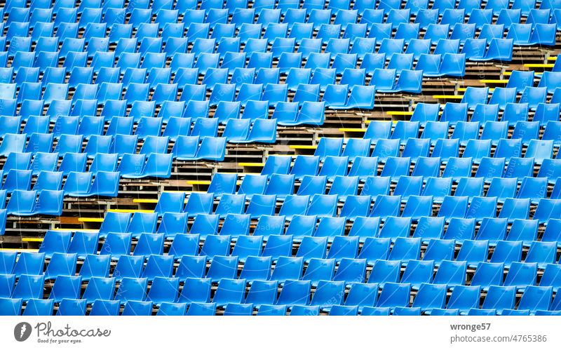 Blue Monday | Grandstand with blue seats and aisle leading diagonally through the picture Grandstands Stands Blue seats rows of seats chairs Seating capacity