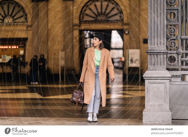 Stylish woman standing in railway station terminal public traveler arrive trip journey adventure infrastructure style outfit trendy appearance feminine female