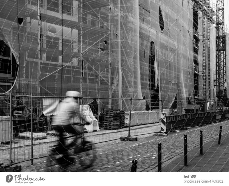 fast cyclist in front of construction site in city Cycling with helmet ride a bicycle Construction site downtown cycle path motion blur Wheel Lanes & trails