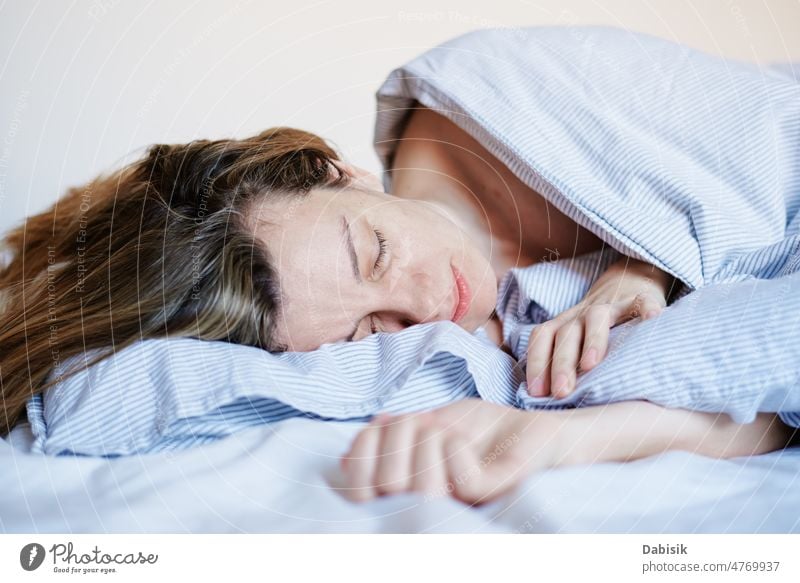 Young beautiful woman sleeping on bed in bedroom Stock Photo by ©belchonock  14333719